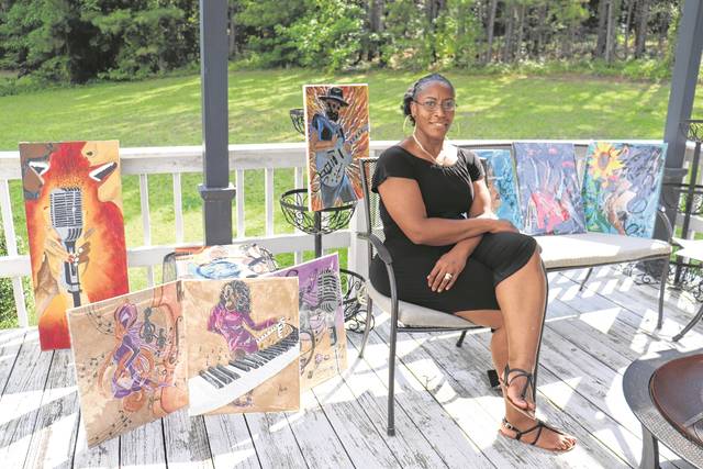 
			
				                                Renee Harden sits with a series of her jazz paintings.
 
			
		