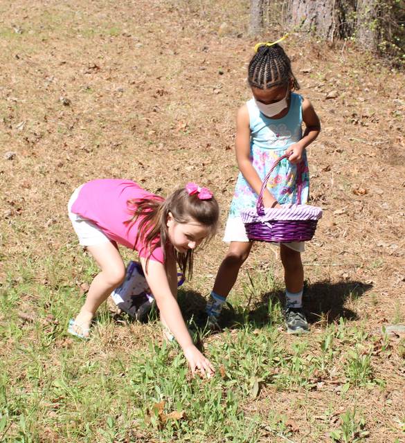 <p>Gavin Stone | Daily Journal</p> <p>Patience Oxendine, left, and Aliana split a group of eggs they found on Easter Sunday. </p>