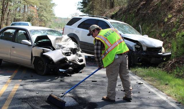  Gavin Stone | Daily Journal A Northside Volunteer Fire Department volunteer helps clean up Ledbetter Road after a wreck on Sunday. 