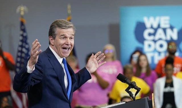  AP Photo | Susan Walsh North Carolina Gov. Roy Cooper speaks before President Joe Biden during a visit to a mobile vaccination unit at the Green Road Community Center in Raleigh, N.C., Thursday, June 24, 2021. 