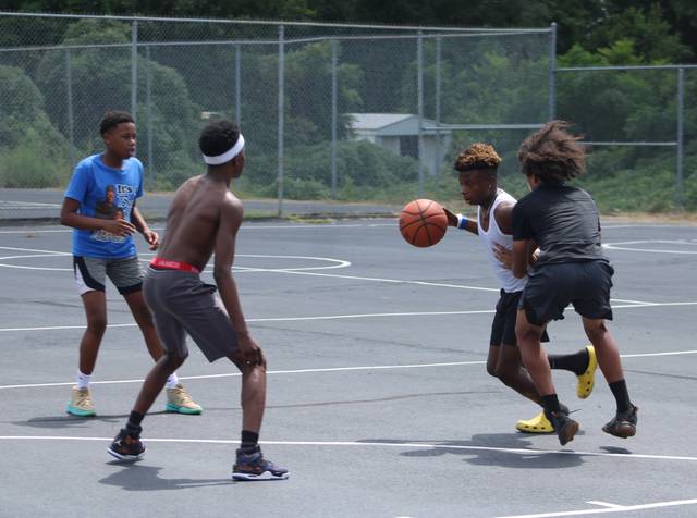 <p>Dobbins Heights teens play a friendly game of basketball on Saturday at the Community Safe event.</p> <p>Gavin Stone | Daily Journal</p>
