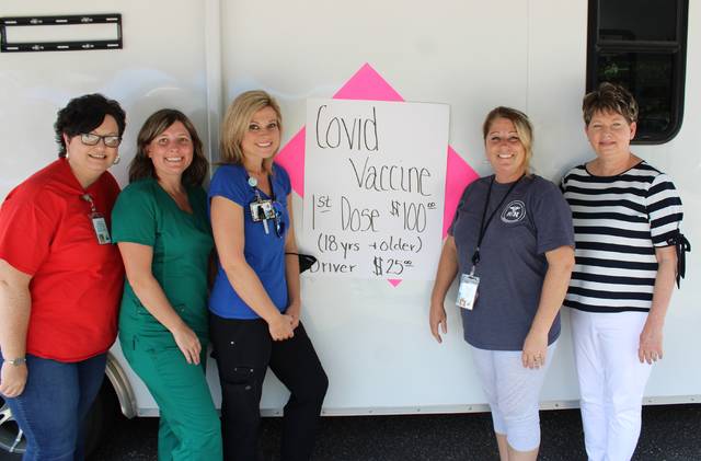 <p>Richmond County Health Department staff Allison Smith, Kim Graves, Heather Taylor, Holly Haire, and Interim Health Director Cheryl Speight pose at their trailer on Saturday where they were giving out free COVID-19 vaccines.</p> <p>Gavin Stone | Daily Journal</p>