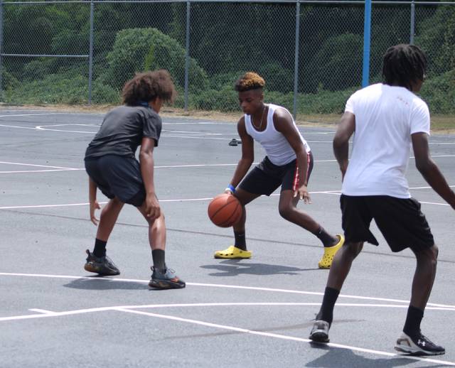 <p>Dobbins Heights teens play a friendly game of basketball on Saturday at the Community Safe event.</p> <p>Gavin Stone | Daily Journal</p>