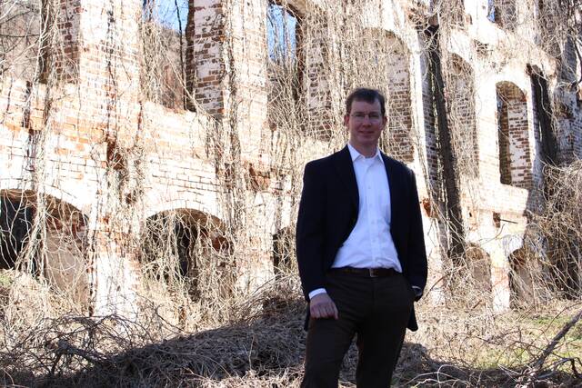 
			
				                                John Hutchinson at the Great Falls Mill ruins, the inspiration for his financial planning business’s name, Great Falls Wealth Management.
 
			
		