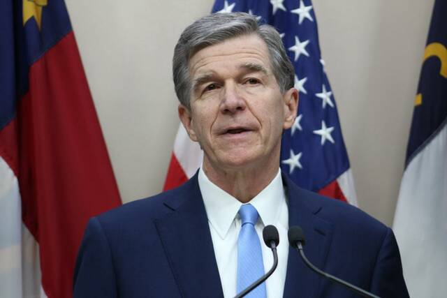 
			
				                                AP Photo | Bryan Anderson, File
                                North Carolina Democratic Gov. Roy Cooper holds a news conference in the state Administration Building on Tuesday, Nov. 16, 2021, in Raleigh, N.C. North Carolina, the nation’s ninth-largest state, was the last to enact a budget for 2021. The governor’s signature capped a year in which Cooper agreed with Republican House Speaker Tim Moore and Republican Senate leader Phil Berger that good-faith negotiations, rather than stalemate, was the path to take.
 
			
		