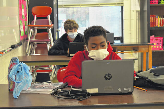 
			
				                                Daily Journal file photo
                                Students wear masks while they work in class during the pandemic.
 
			
		