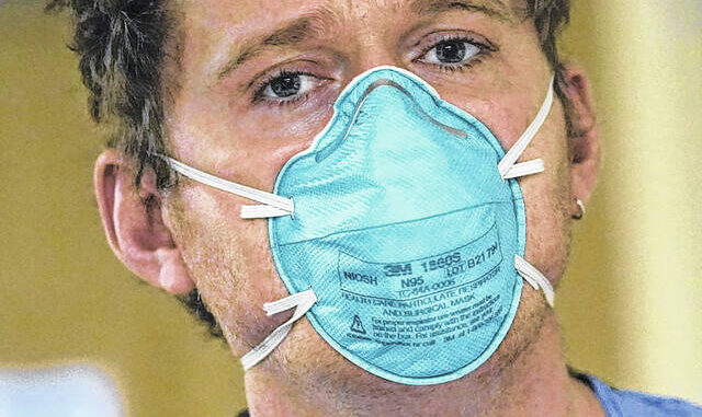 
			
				                                AP Photo | Elaine Thompson
                                Registered nurse Scott McGieson wears an N95 mask as he walks out of a patients room in the acute care unit of Harborview Medical Center, Friday, Jan. 14, 2022, in Seattle. 
 
			
		