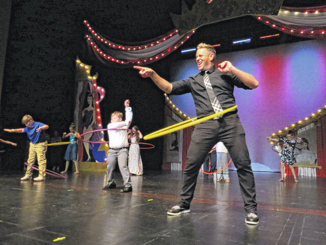 Judge Eric McCotter joins in during one of the intermission activities in which volunteers competed to hula hoop the longest at the 2019 Dancing with the Stars event.
                                 Daily Journal file photo