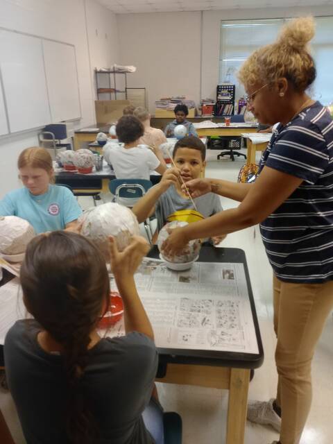 <p>Elijah Barber helps Ms. Krishna poke a hole in the balloon, while Addy Chappell, left, puts some finishing touches on her balloon. “I’m trying to incorporate a lot more STEM in my classroom,” Krishna said. “It’s really important to do cross curriculum, especially science and math.”</p>
                                 <p>Lauren Monica | Daily Journal</p>