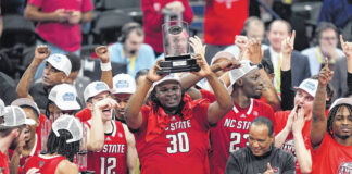 
			
				                                North Carolina State forward DJ Burns Jr. (30) hoists the MVP trophy as he joins his teammates as they celebrate winning an NCAA college basketball game against North Carolina to win the championship of the Atlantic Coast Conference tournament on Saturday in Washington. North Carolina State won 84-76.
                                 Susan Walsh | AP photo

			
		